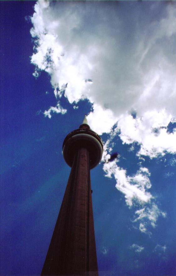 CN tower with the sun peekin threw the clouds