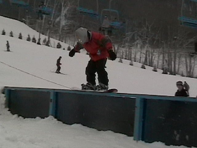 7 year old greasing 30ft rail on snowboard