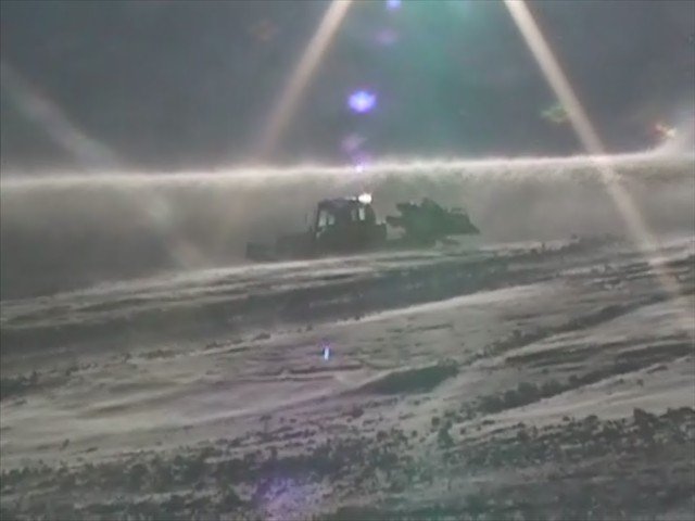 cool shot of snow cat with crazzy wind blowing around
