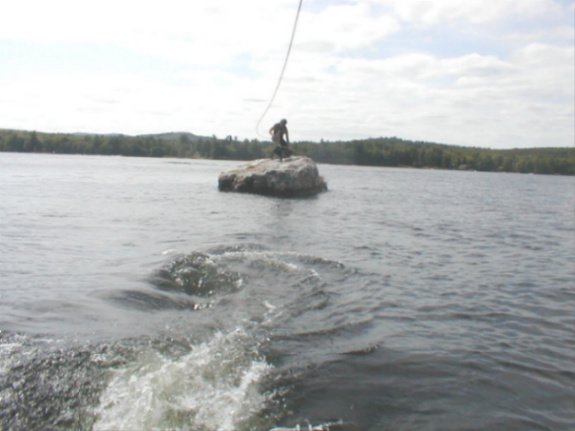 A Drop On Wakeskate off a rock covered in shit