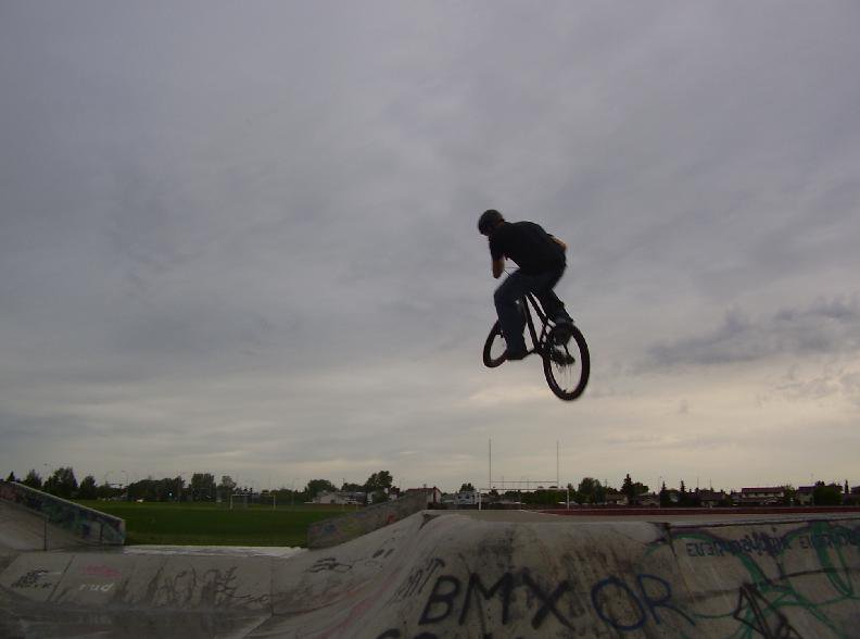 biker goin big in the rain