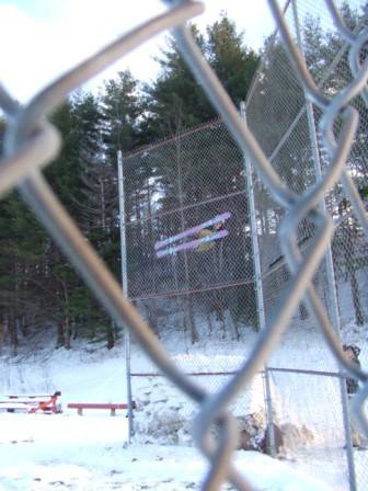 sick backstop shot through chainlink