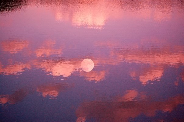 Overlay moon and glass reflection on water of sunset