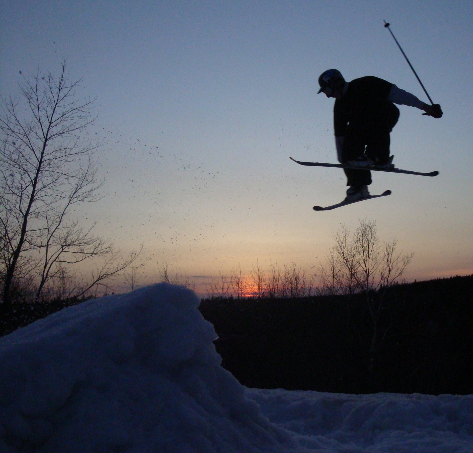 Skiing off a triangular prism hand constructed from snow