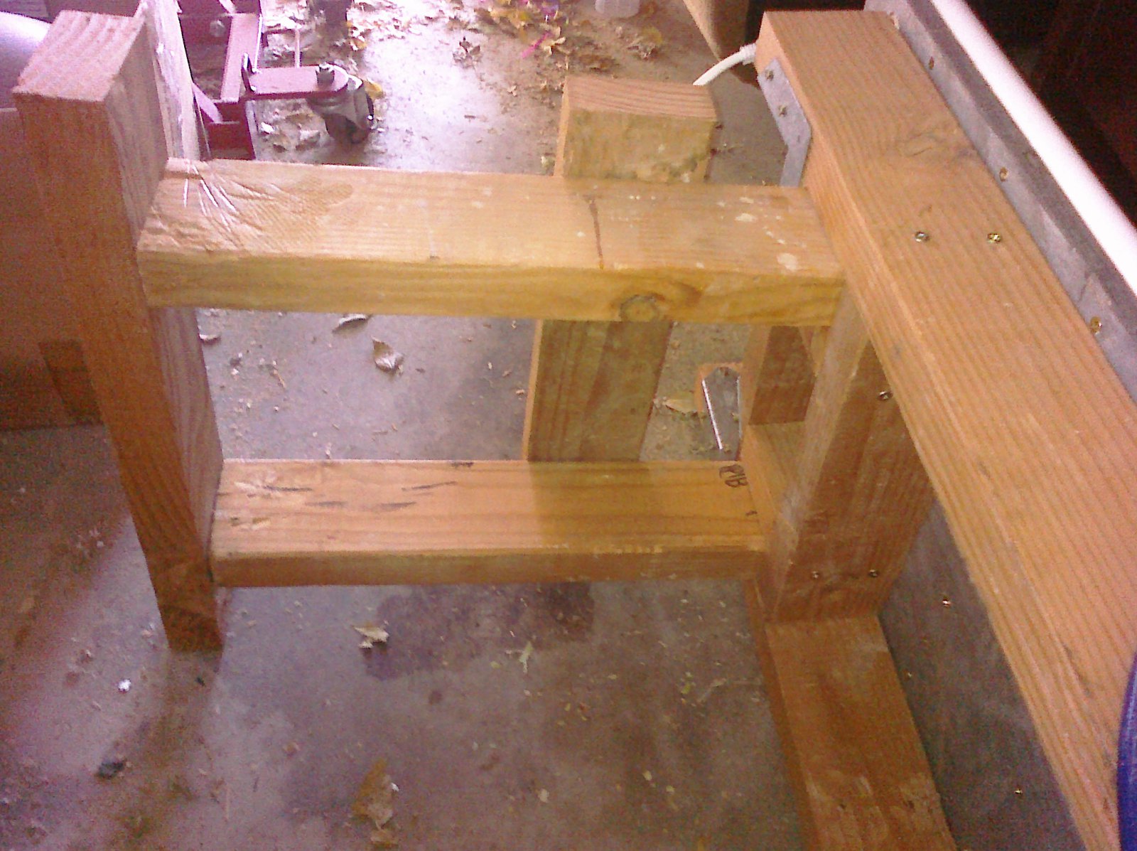 Legs inserted into slots under box.